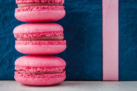 Pink macaroon on a blue background horizontal