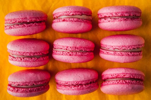 Pink macaroon on a yellow tablecloth horizontal
