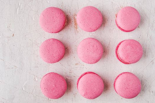 Pink macaroon on a white table horizontal, top view