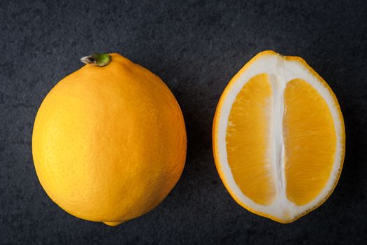 Yellow lemons on a blue stone table horizontal