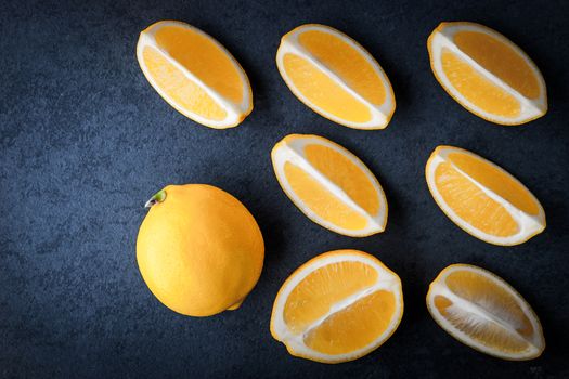 Yellow lemons on a blue stone table horizontal