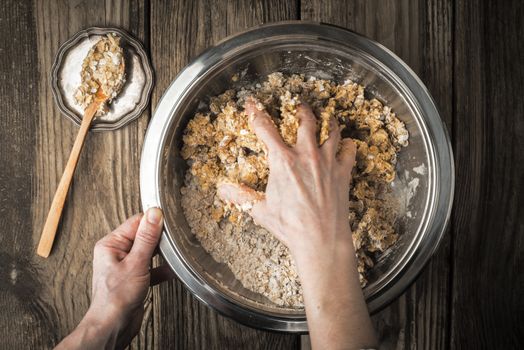 Kneading dough to cook biscuits in a metal plate horizontal