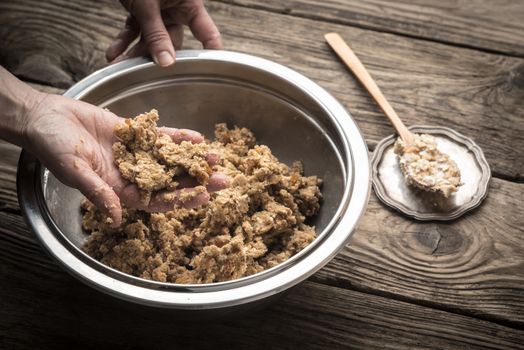 Kneading dough to cook biscuits in a metal plate horizontal