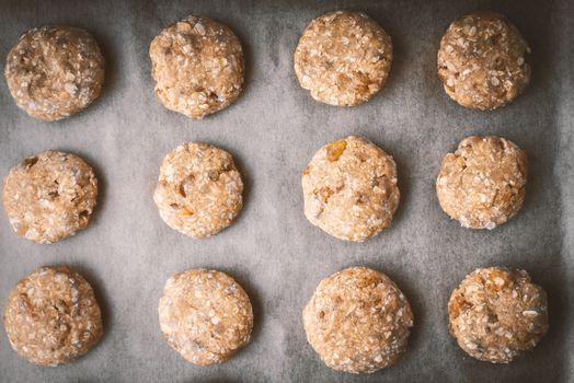 Oatmeal cookies on a baking sheet covered with parchment horizontal