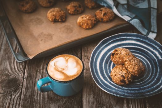 Oatmeal cookies and coffee cup on a wooden table horizontal