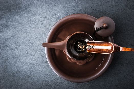 Kettle for tea ceremony on a blue stone table horizontal