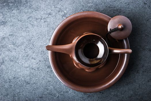 Kettle for tea ceremony on a blue stone table horizontal