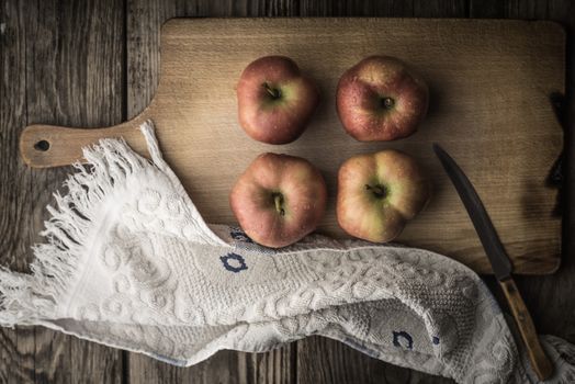 Red apples and towel on the cutting board horizontal