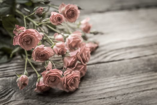 Bouquet of roses on old wooden boards horizontal