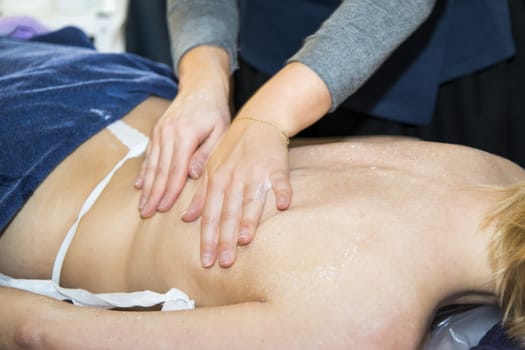 Massaging of young woman in SPA