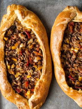 close up of rustic golden turkish pide bread pizza