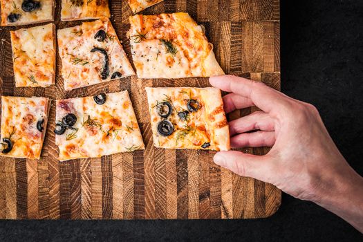 Slices of pizza on a wooden board horizontal