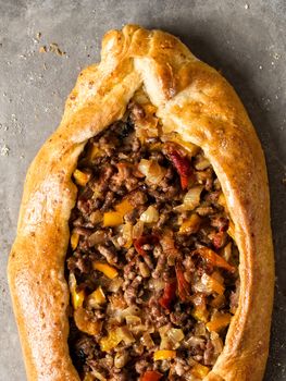 close up of rustic golden turkish pide bread pizza