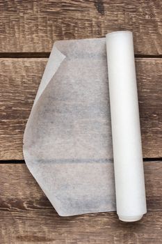 An open roll of paper on the wooden table background