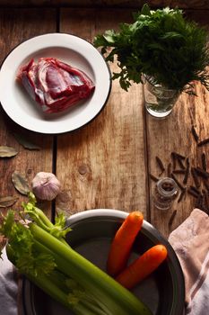 Ingredients for the meat broth on the wooden table