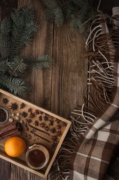 Orange , honey and spices on the wooden tray  with plaid vertical