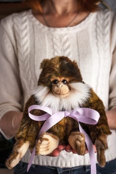 Monkey toy  with violet ribbon in the hands vertical