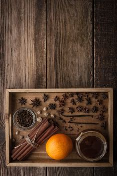 Orange , honey and spices on the wooden tray vertical