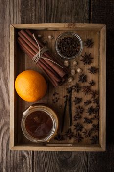 Orange , honey and spices on the wooden tray top view