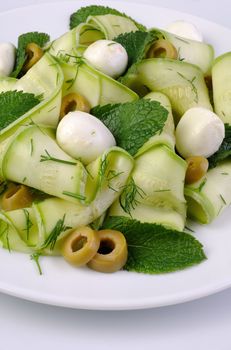 Zucchini salad with mozzarella, olives, dill and mint