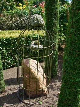 Beautiful creative decoration made of stone in a lush green garden   