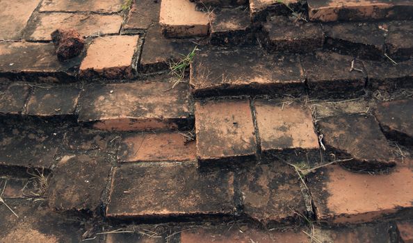 Weathered texture of stained old dark brown and red brick wall background