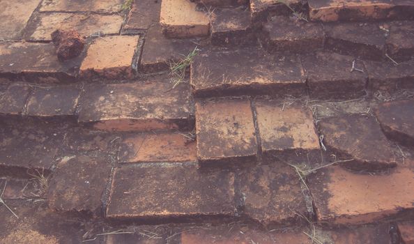 Weathered texture of stained old dark brown and red brick wall background