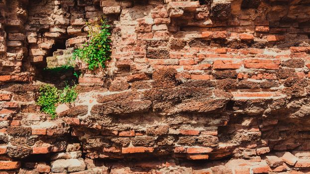 Weathered texture of stained old dark brown and red brick wall background