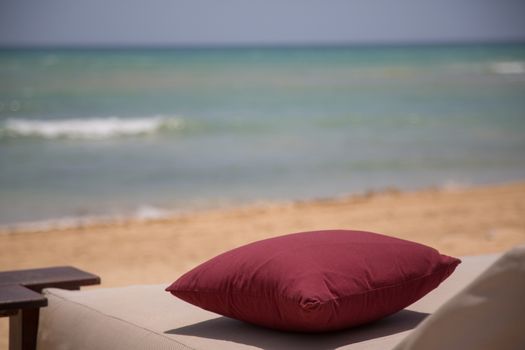 Pillow at the beach with ocean in background