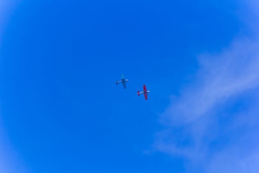 Photo of two flying military airplanes in blue sky