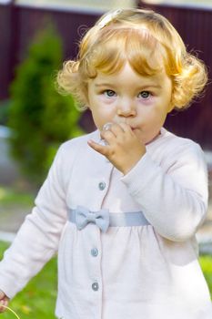 Portrait of cute baby girl with curly blond hair