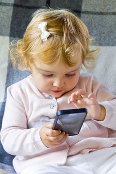 Caucasian cute infant girl with mobile phone