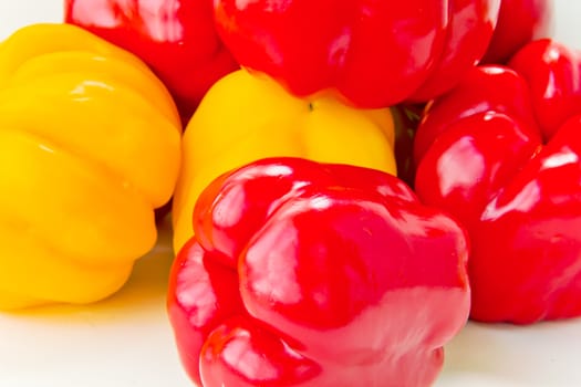 Photo of fresh red and yellow raw pepper on white background