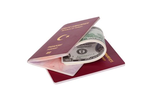 Finance concept, stack of hundred dollar money banknotes in passport with the text Republic of Turkey in Turkish, isolated on white background.