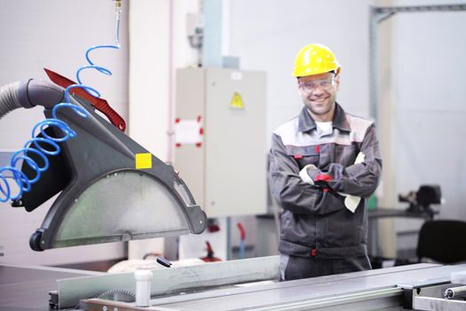 Worker at CNC machine shop with lathes