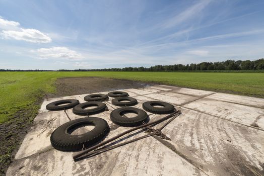 Switched tires as a machine at the back of the tractor to level out bumpy agricultural field
