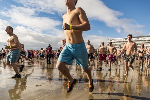 OLD ORCHARD BEACH - JANUARY 1 2016: several hundred people took part in the annual Lobster Dip Plunging on January 1, 2016 in Old Orchard Beach, Maine USA