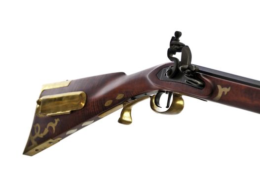 close up view of black powder rifle showing the brass inlays and patch box on the stock.