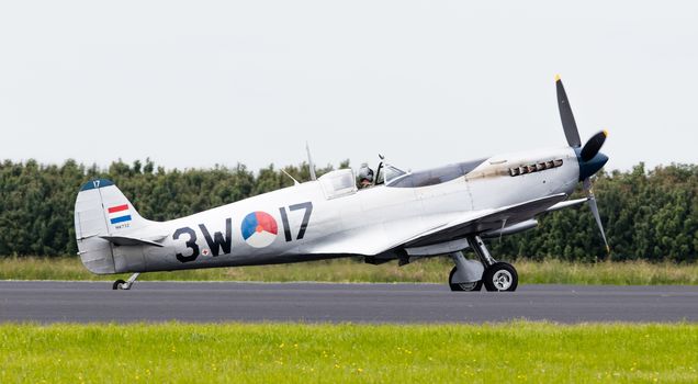 LEEUWARDEN, THE NETHERLANDS - JUNE 10, 2016: A vintage Spitfire fighter plane on the runway during a demonstration at the Royal Netherlands Air Force Days at Leeuwarden on June 10, 2016.