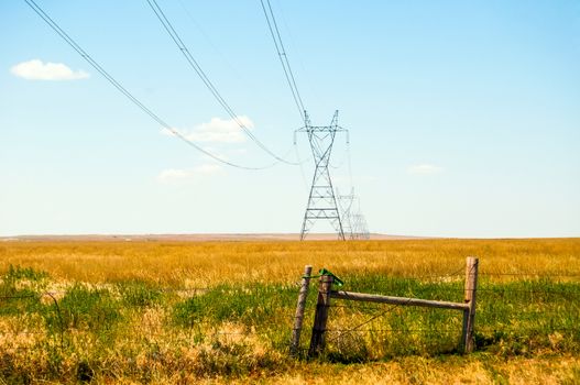 High voltage power lines crossing the open prairie in north central Colorado, USA