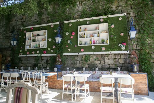 Interior beautiful street cafe with climbing plants