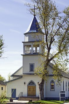 Christian church with a steeple topped with a cross.