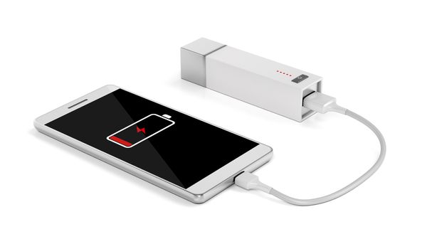 Smartphone charging with power bank on white background 