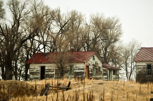 Ramshackle farm buildings empty and abandoned on the Colorado, USA high plains.