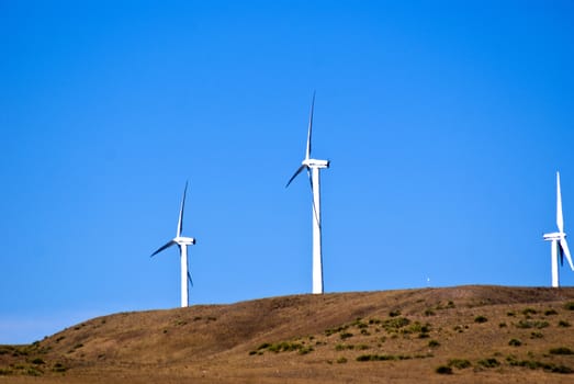Wind turbines making electricity on a windy hill
