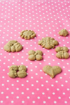 shortbread biscuits figure on a pink background.
