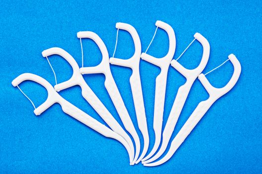 Oral Device Dental white floss on blue background.
