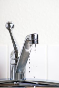 Dripping faucet leaking into the sink in the kitchen