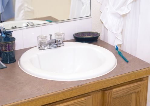 Bathroom sink and counter in a modern middle class home.