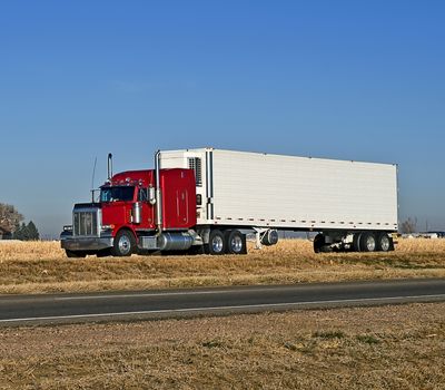 Semi-truck hauling a refrigerated load of freight.